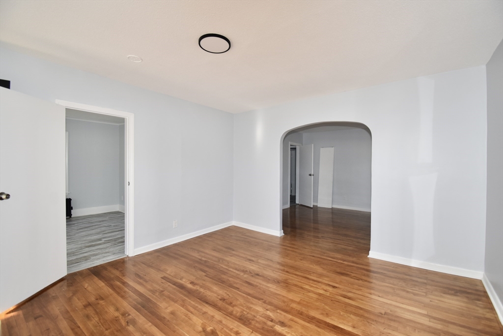 46-48 Wait Street Springfield, MA 01104 - Photo 27 of 40 a view of an empty room with wooden floor and a window
