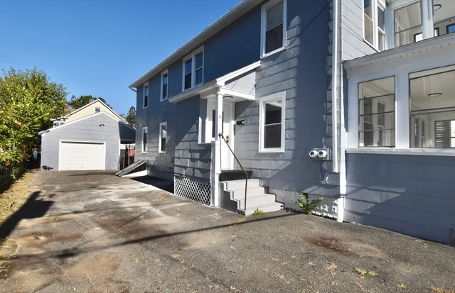 a view of a house with a yard and garage