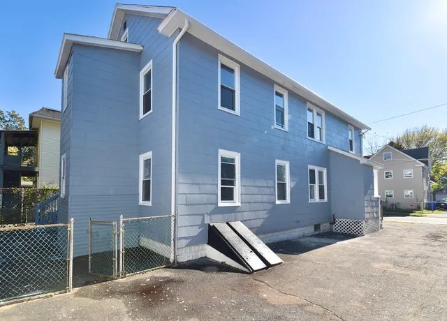 a front view of a house with parking space