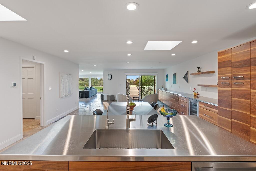 4811 Lakeridge Terrace West Reno, NV 89509 - Photo 15 of 43 a kitchen with kitchen island a sink and a view of living room