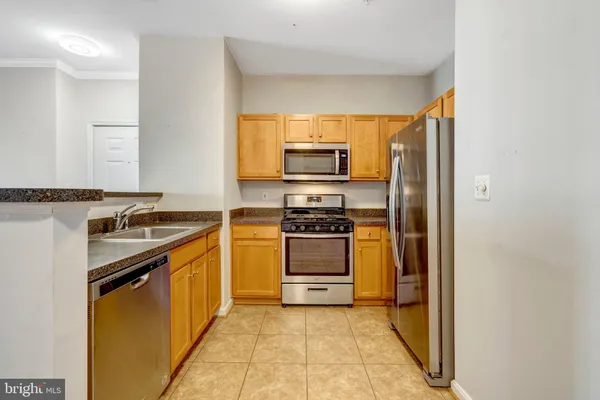 a kitchen with a sink stove and refrigerator