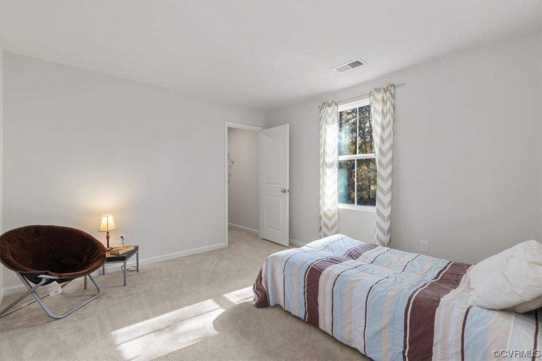 8443 Evening Star Place Richmond, VA 23235 - Photo 11 of 33 a bedroom with a bed tv and chair