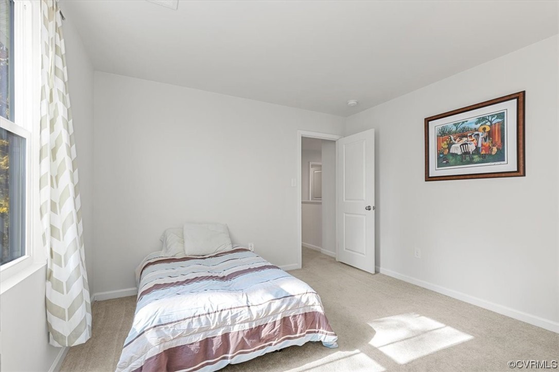 8443 Evening Star Place Richmond, VA 23235 - Photo 13 of 33 a bedroom with a bed and a window