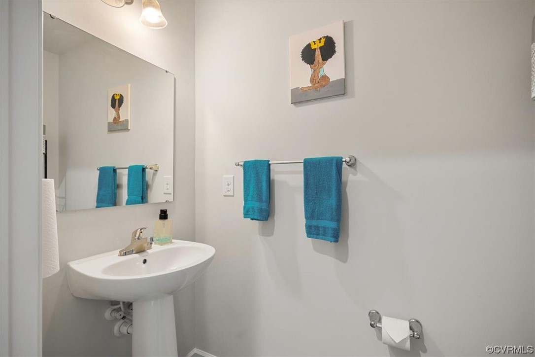 8443 Evening Star Place Richmond, VA 23235 - Photo 28 of 33 a bathroom with a sink and a mirror
