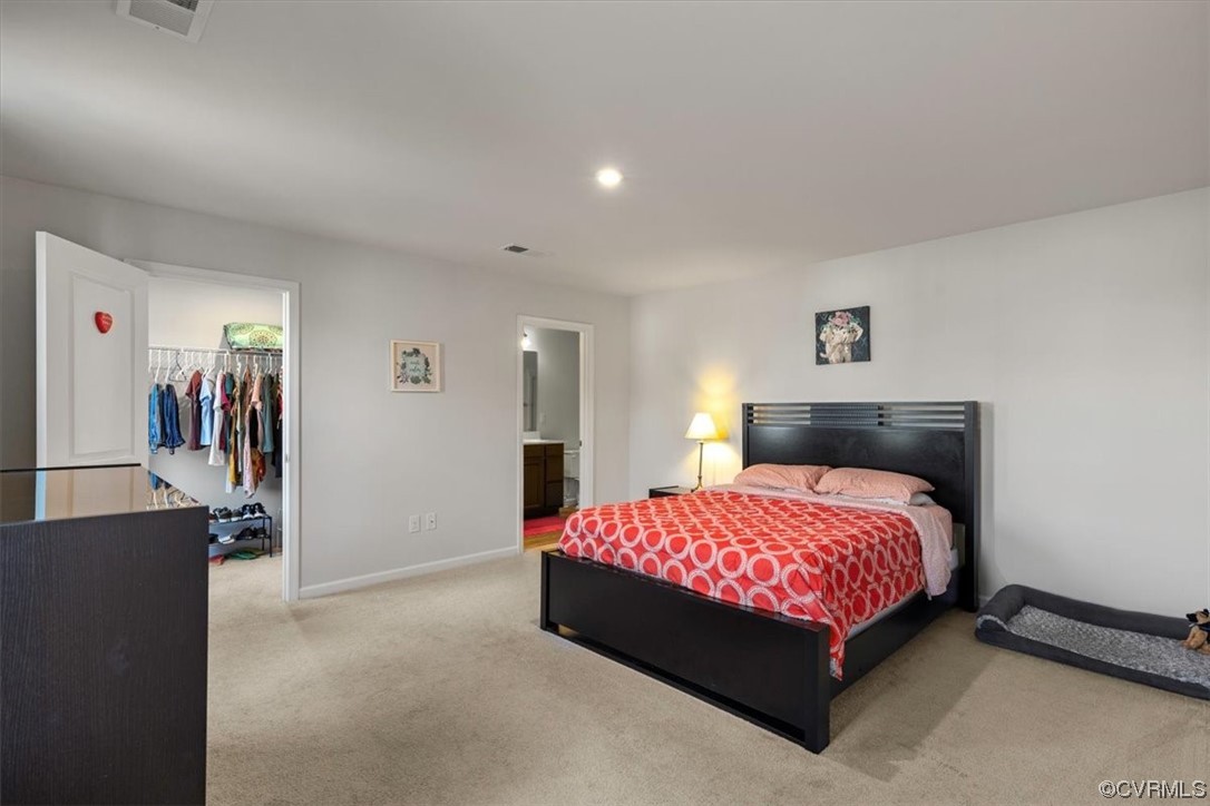 8443 Evening Star Place Richmond, VA 23235 - Photo 4 of 33 a bedroom with a bed and a walk in closet