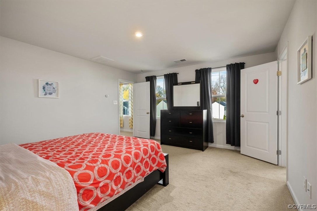 8443 Evening Star Place Richmond, VA 23235 - Photo 6 of 33 a bedroom with a bed and a large mirror