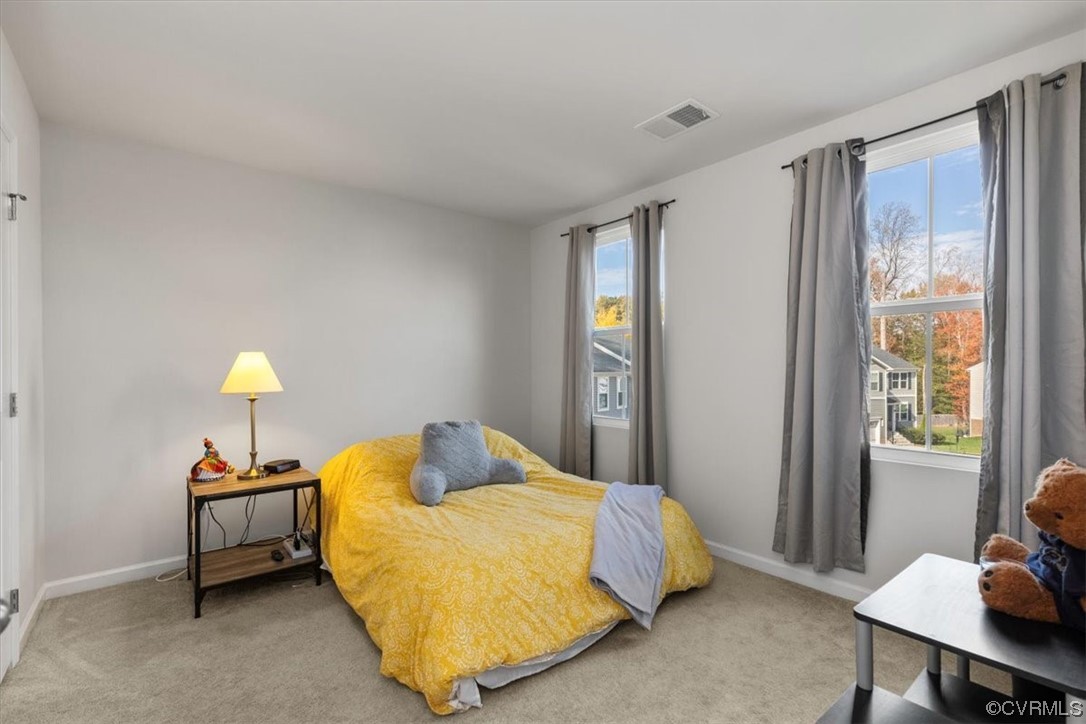 8443 Evening Star Place Richmond, VA 23235 - Photo 8 of 33 a bedroom with a bed and a window