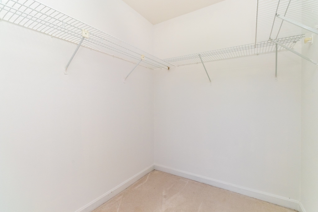 60e Glen Road, Unit 306 Brookline, MA 02445 - Photo 21 of 27 a view of a room with racks on the wall