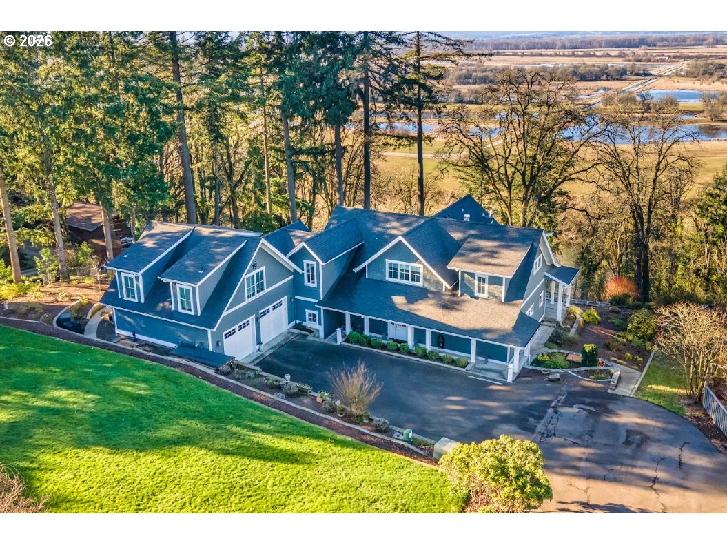 an aerial view of a house with garden space and a patio