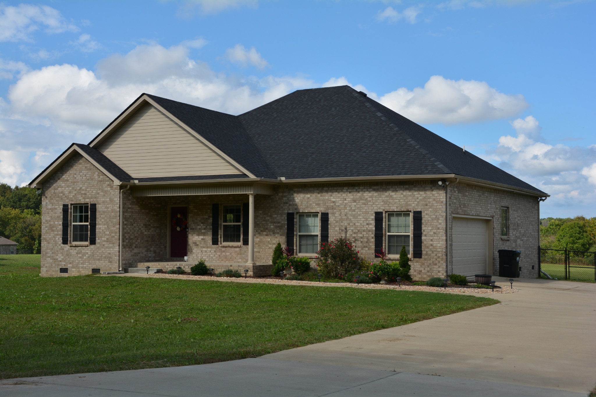 675 Elrod Road Manchester, TN 37355 - Photo 1 of 39 a front view of a house with a garden and plants