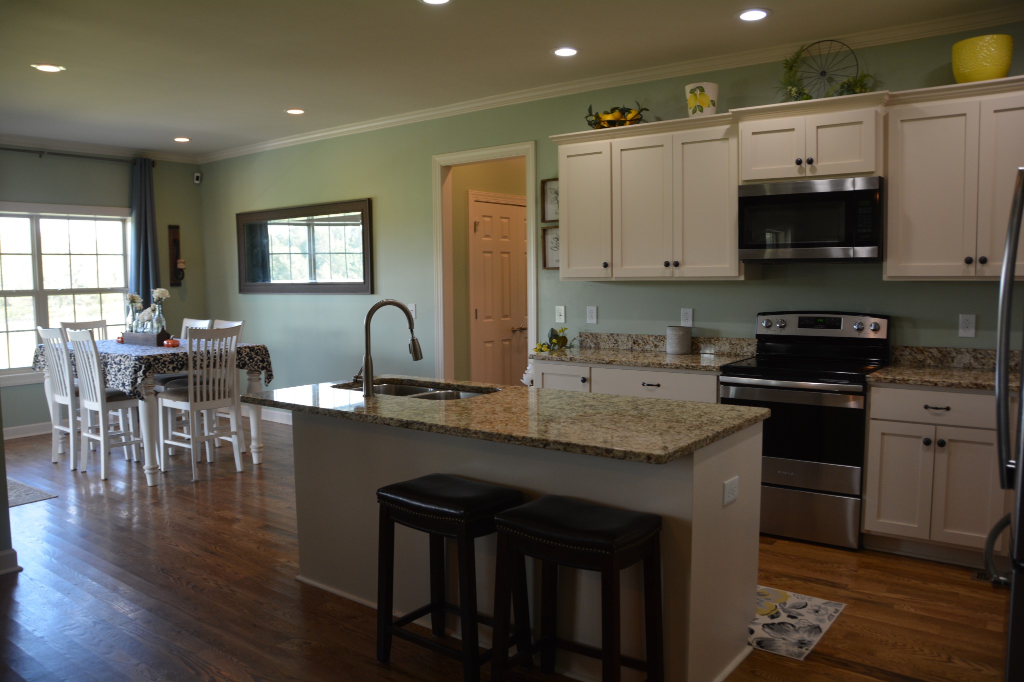 675 Elrod Road Manchester, TN 37355 - Photo 17 of 39 a kitchen with granite countertop a stove a sink a dining table and chairs