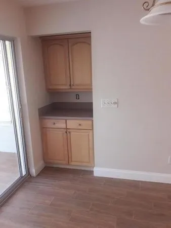 a view of cabinets and wooden floor