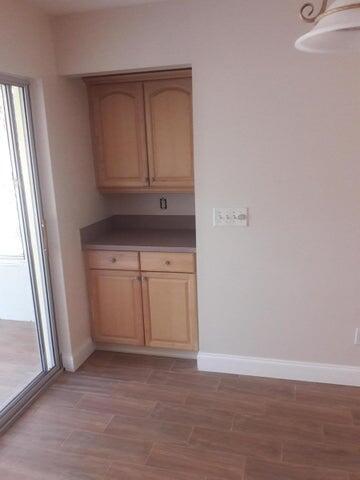 721 Southeast Stypmann Boulevard Stuart, FL 34994 - Photo 3 of 9 a view of cabinets and wooden floor