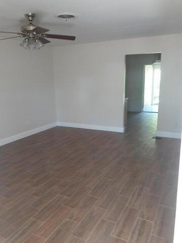 721 Southeast Stypmann Boulevard Stuart, FL 34994 - Photo 4 of 9 wooden floor in a empty room