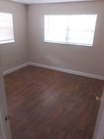 721 Southeast Stypmann Boulevard Stuart, FL 34994 - Photo 7 of 9 an empty room with a window