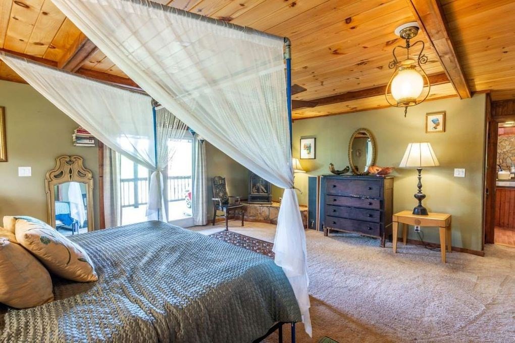 68 Dorr Spring Spring City, TN 37381 - Photo 16 of 42 a spacious bedroom with a bed table and a chair