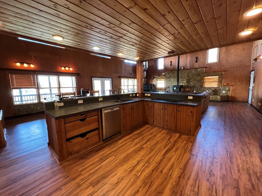 68 Dorr Spring Spring City, TN 37381 - Photo 36 of 42 a kitchen with wooden floors and wooden cabinets