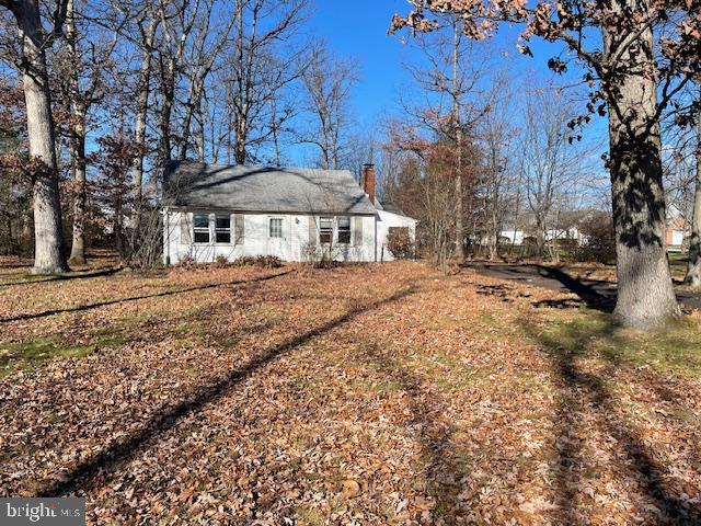 a front view of a house with a yard covered with snow
