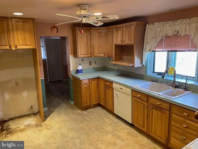 a kitchen with stainless steel appliances granite countertop a sink refrigerator and cabinets