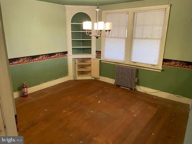 a view of a room with shelves windows and wooden floor