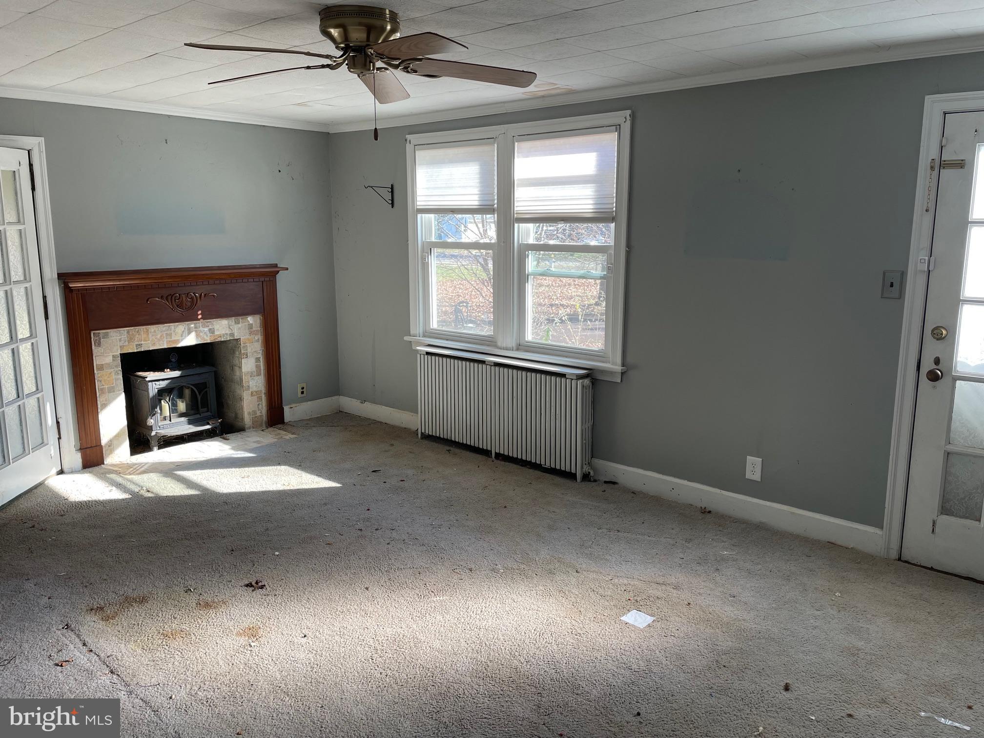 1306 West Orvilla Road Hatfield, PA 19440 - Photo 10 of 14 an empty room with fireplace and windows