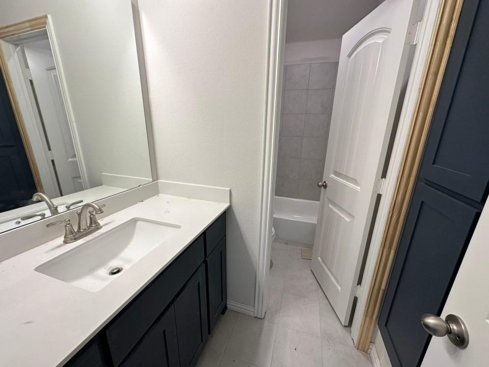 1100 Trinity Drive Springtown, TX 76082 - Photo 13 of 15 a bathroom with a sink a toilet a tub and a mirror