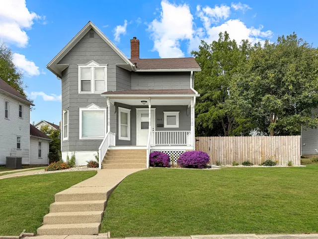 a front view of house with yard and green space