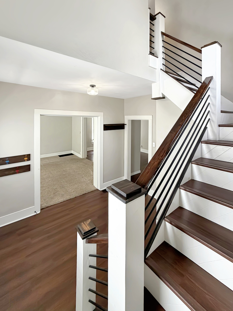 840 West Homer Street Freeport, IL 61032 - Photo 3 of 23 a view of a hallway with wooden floor and staircase