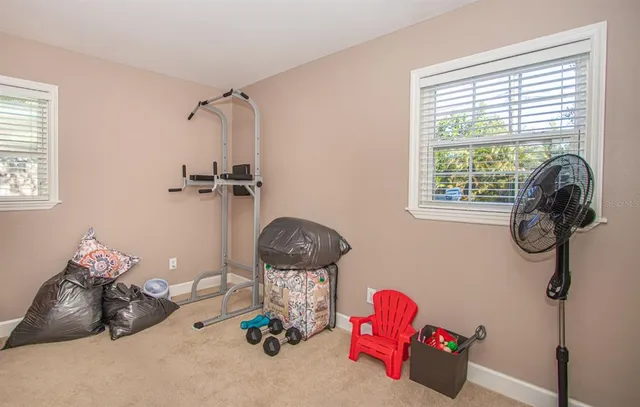 a bedroom with a bed two lamps and a window