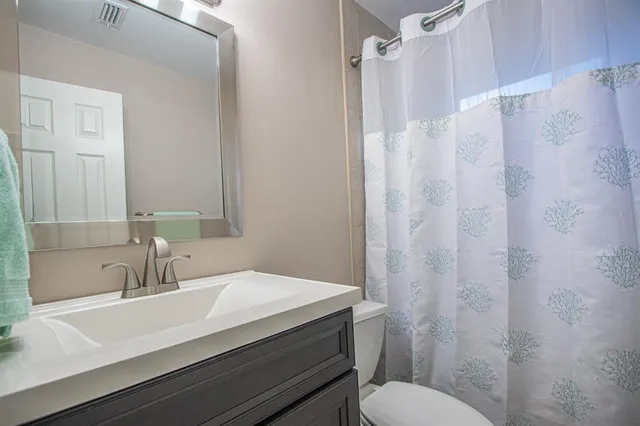 a view of backyard with swimming pool and table and chairs under an umbrella