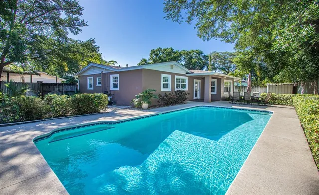 a view of a backyard with a small cabin and wooden fence