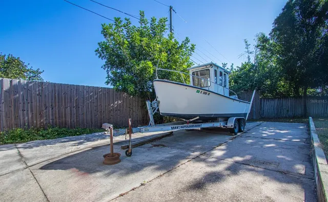 a view of a chairs and table in backyard of the house