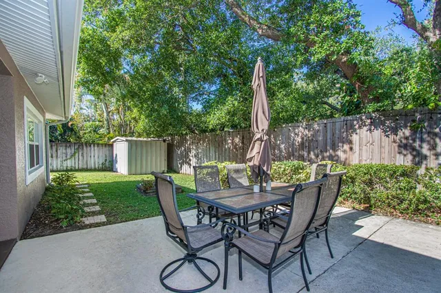 a backyard of a house with table and chairs