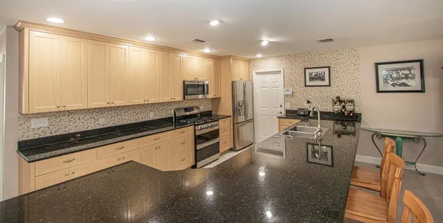 a kitchen with a sink stainless steel appliances and cabinets