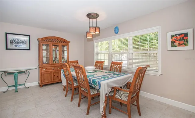 a dining room with furniture and window