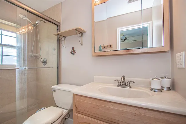 a bathroom with a sink toilet and shower