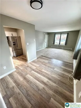 a view of a livingroom with wooden floor and window