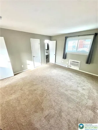 a view of an empty room with a fireplace