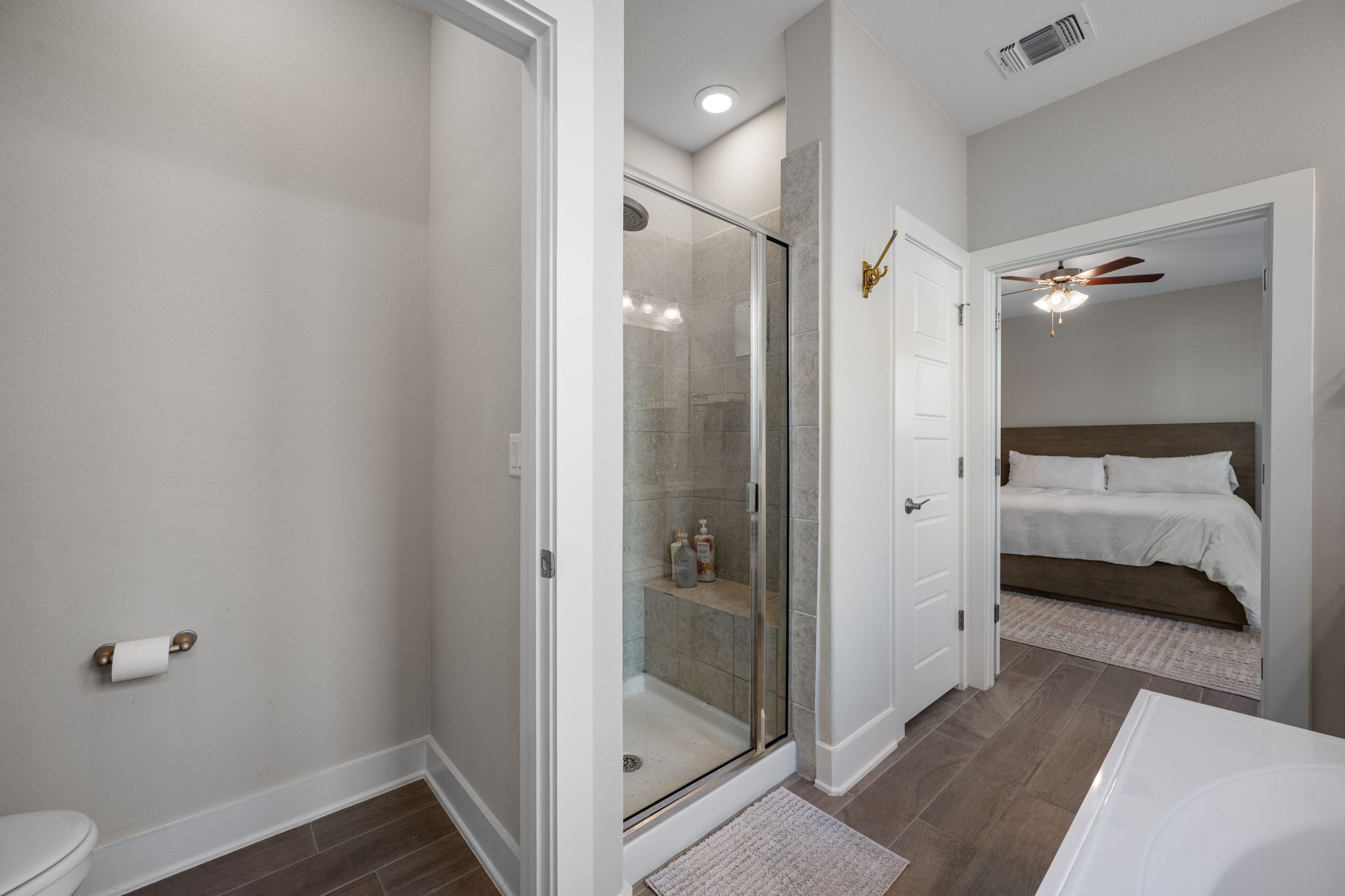 5409 Fox Wing Way Austin, TX 78747 - Photo 12 of 26 A well-appointed bathroom offers a glass-enclosed shower, leading directly to a restful bedroom suite.