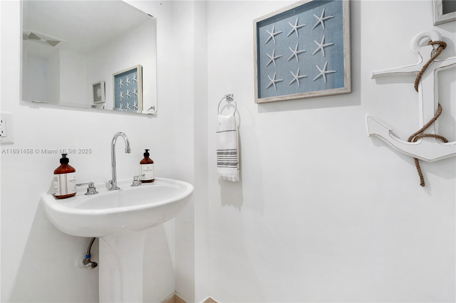 6917 Collins Avenue, Unit 508 Miami Beach, FL 33141 - Photo 11 of 18 a bathroom with a sink a mirror and a shower