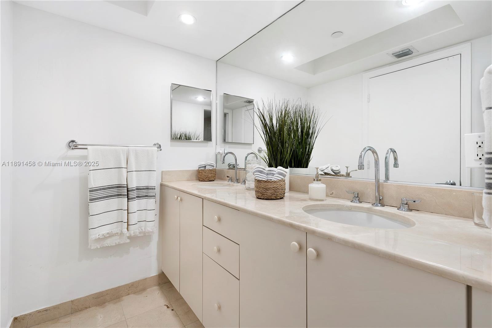 6917 Collins Avenue, Unit 508 Miami Beach, FL 33141 - Photo 12 of 18 a bathroom with a sink and a mirror