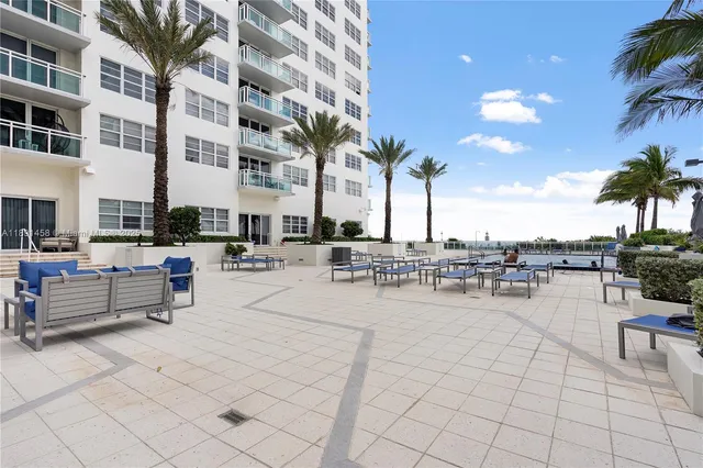 a view of a patio with dining table and chairs