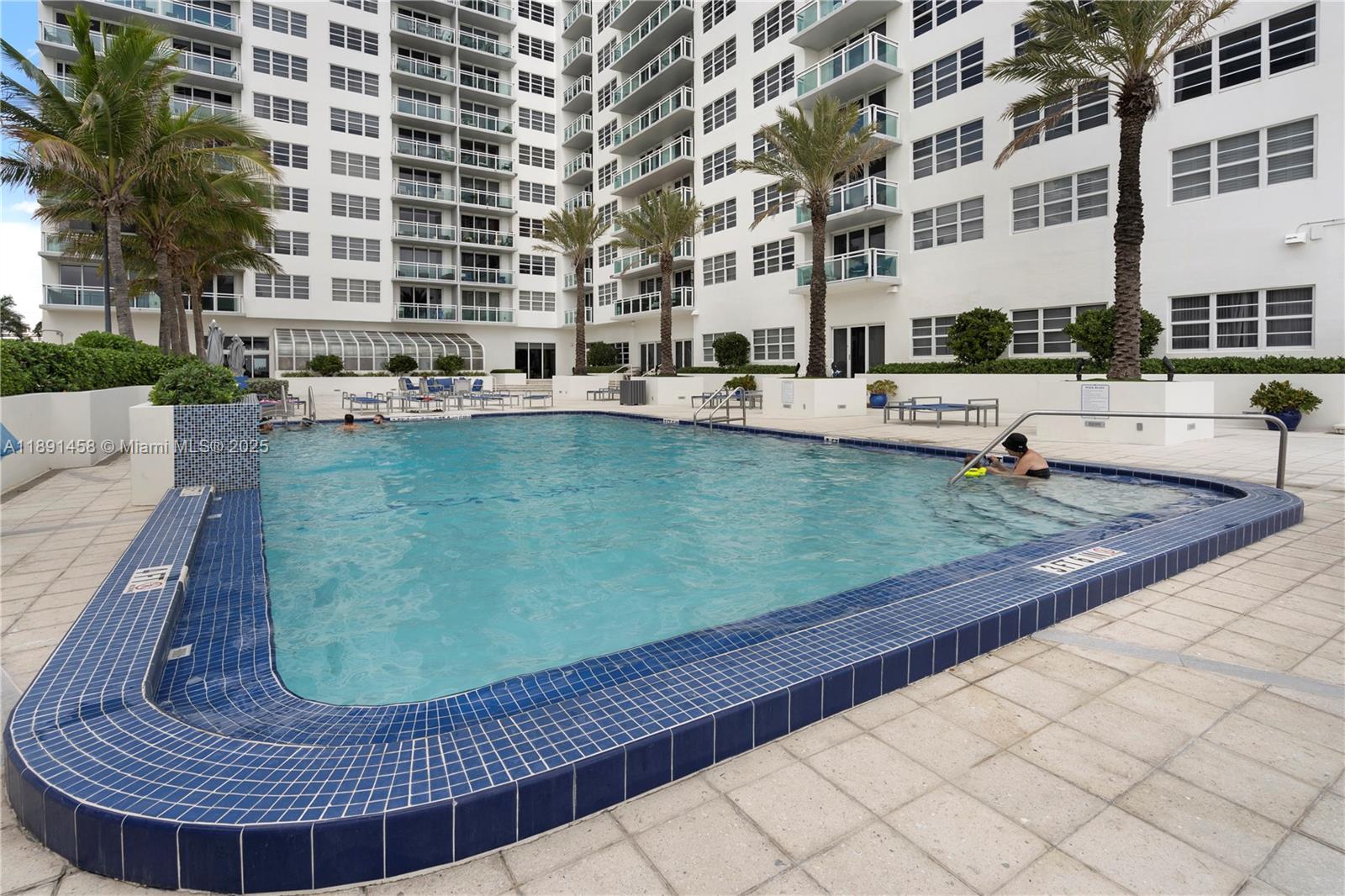 6917 Collins Avenue, Unit 508 Miami Beach, FL 33141 - Photo 15 of 18 a view of a swimming pool with a patio