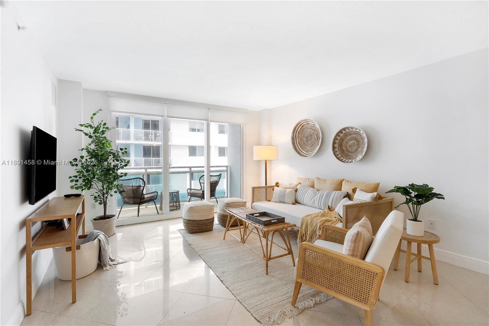 6917 Collins Avenue, Unit 508 Miami Beach, FL 33141 - Photo 3 of 18 a living room with furniture potted plant and a large window