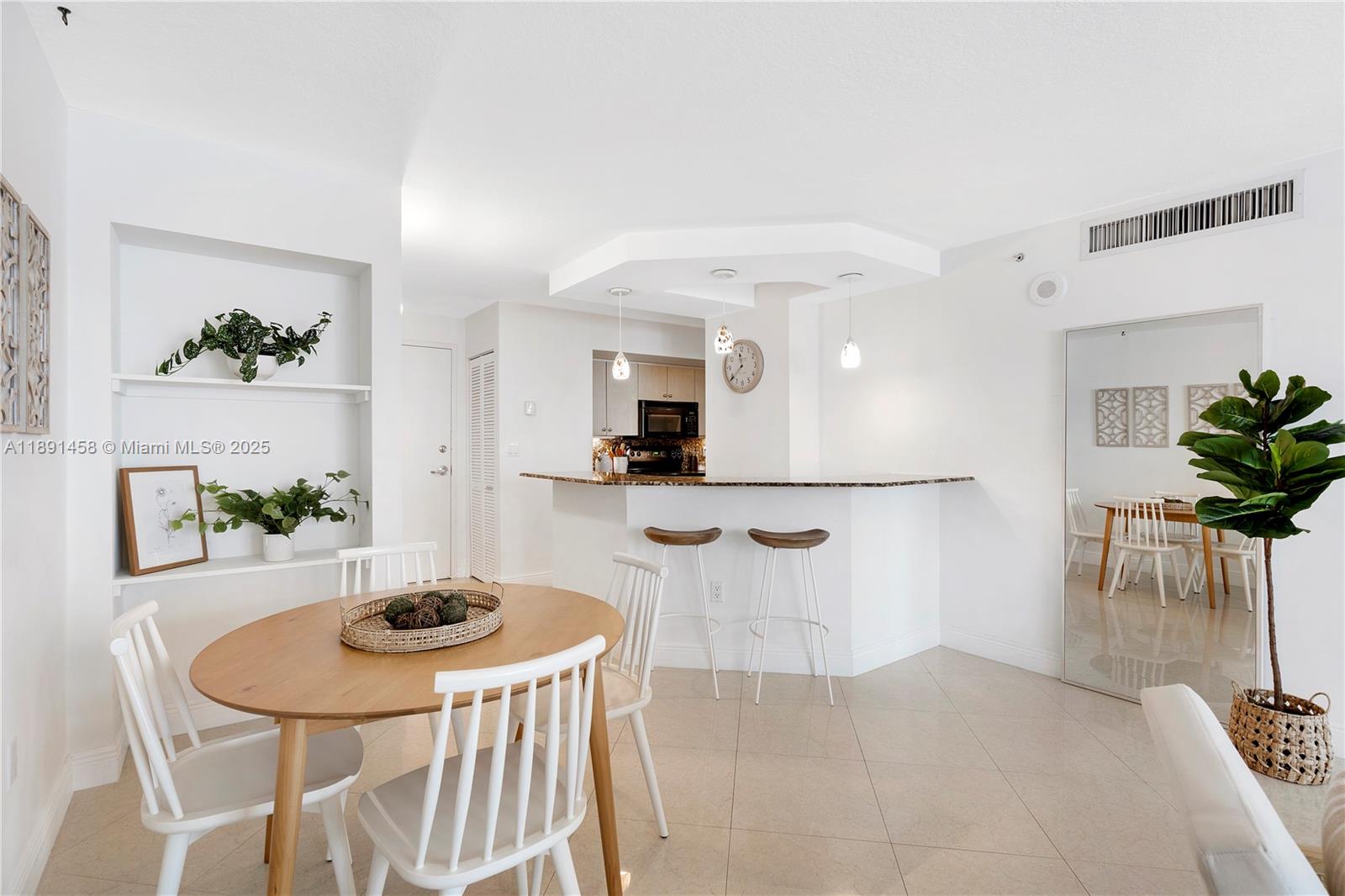 6917 Collins Avenue, Unit 508 Miami Beach, FL 33141 - Photo 4 of 18 a view of kitchen and dining area with furniture