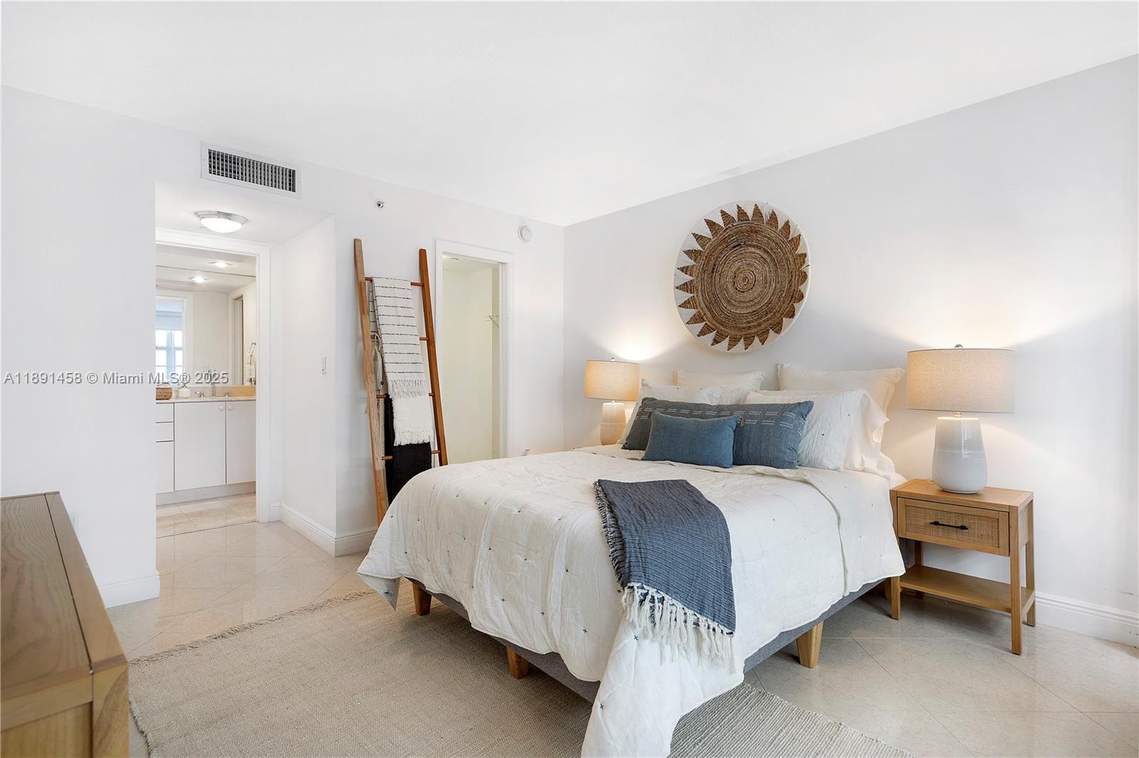 6917 Collins Avenue, Unit 508 Miami Beach, FL 33141 - Photo 9 of 18 a bedroom with a bed and a chandelier