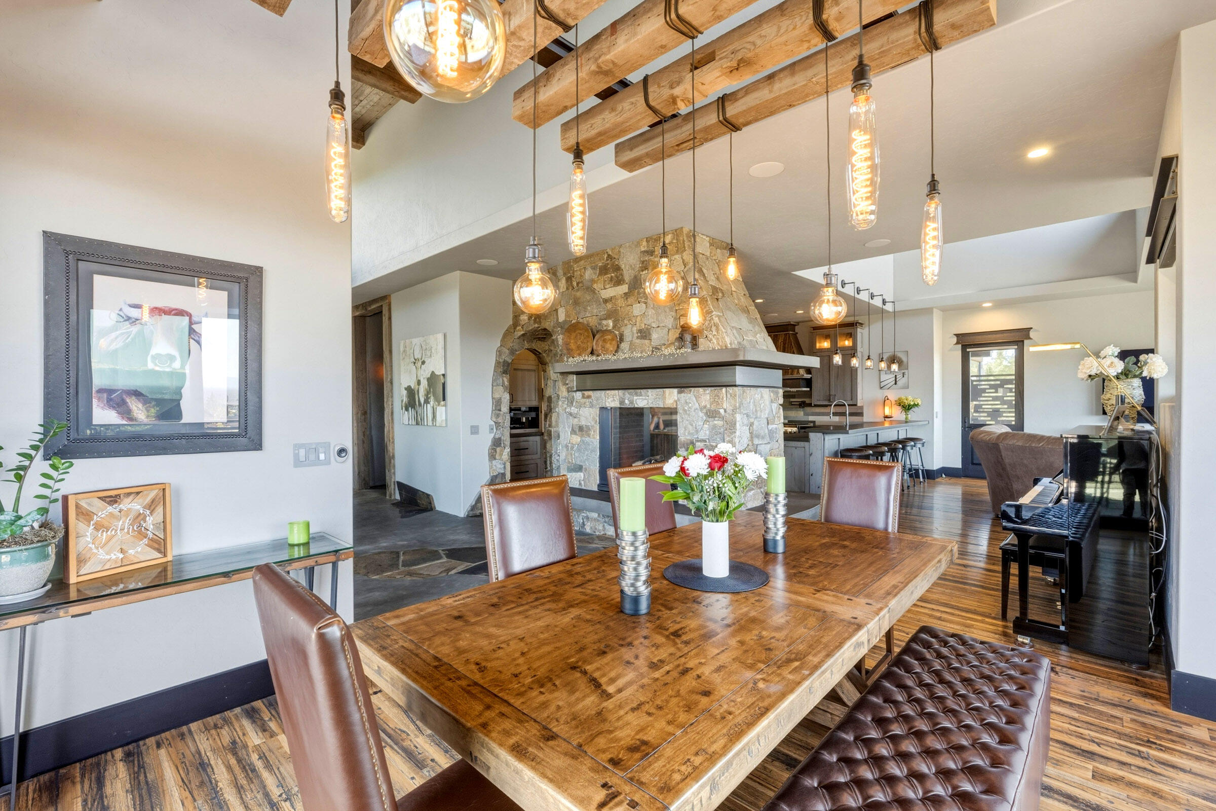 16086 South W Brasada Ranch Road Powell Butte, OR 97753 - Photo 14 of 69 a dining room with wooden floor a chandelier a wooden table and chairs