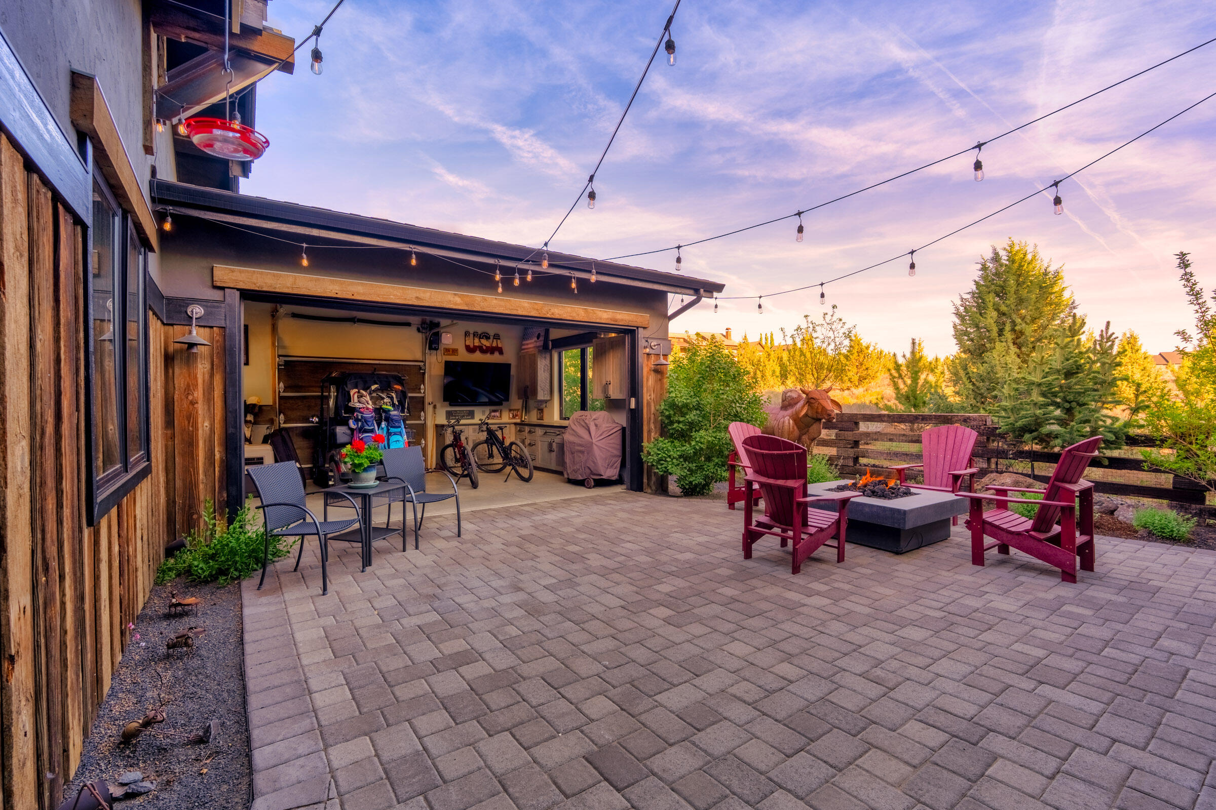 16086 South W Brasada Ranch Road Powell Butte, OR 97753 - Photo 62 of 69 a view of a patio with table and chairs potted plants and a barbeque