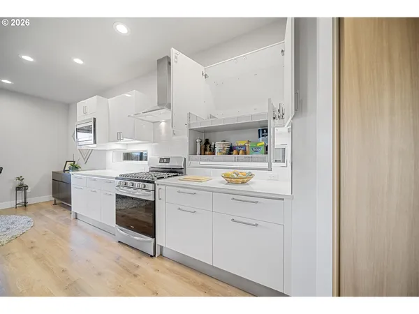 a kitchen with stainless steel appliances granite countertop a stove a sink and a refrigerator