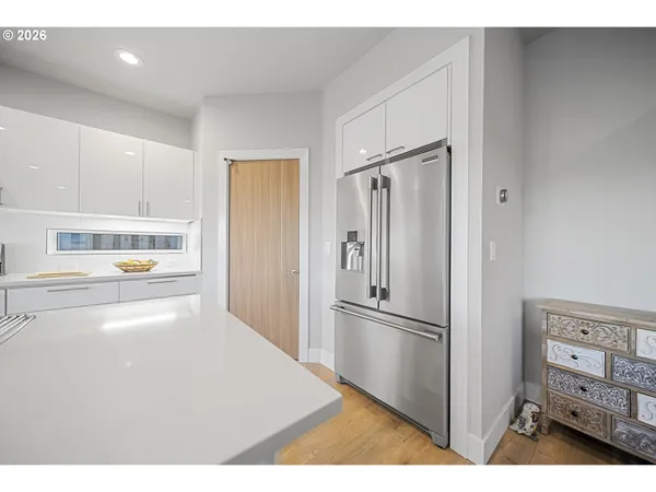 a kitchen with stainless steel appliances a refrigerator and cabinets